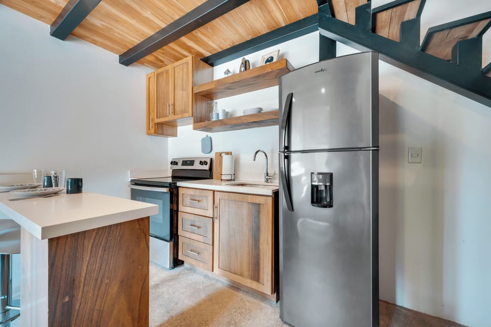 Kitchen — stainless refrigerator, wood cabinets, counter space