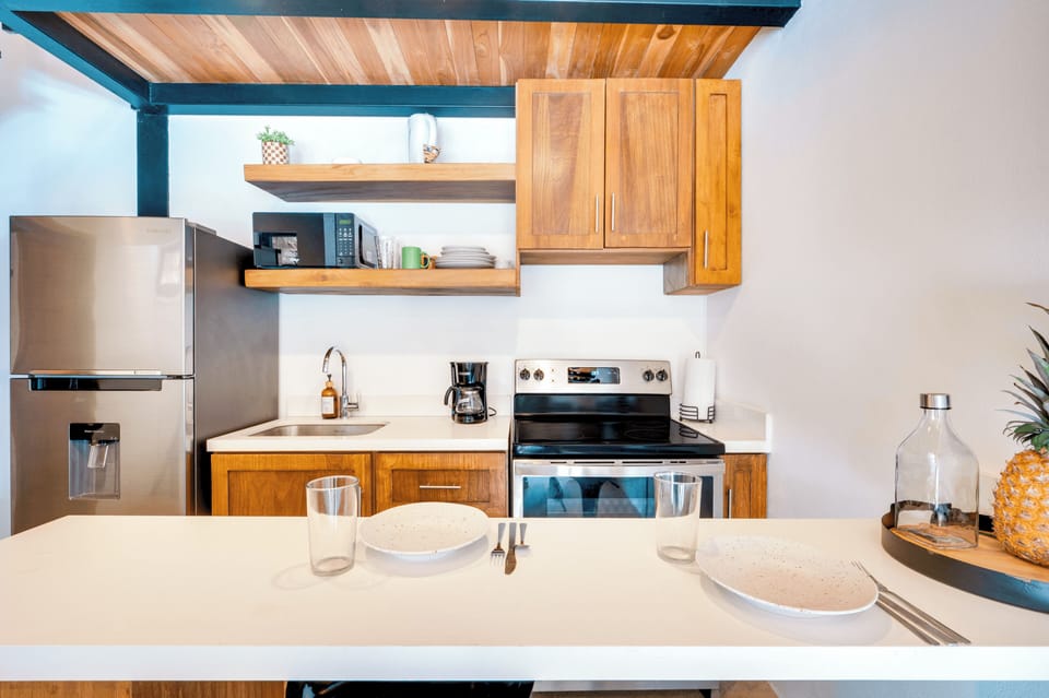 Full kitchen — stainless appliances, wood cabinets.