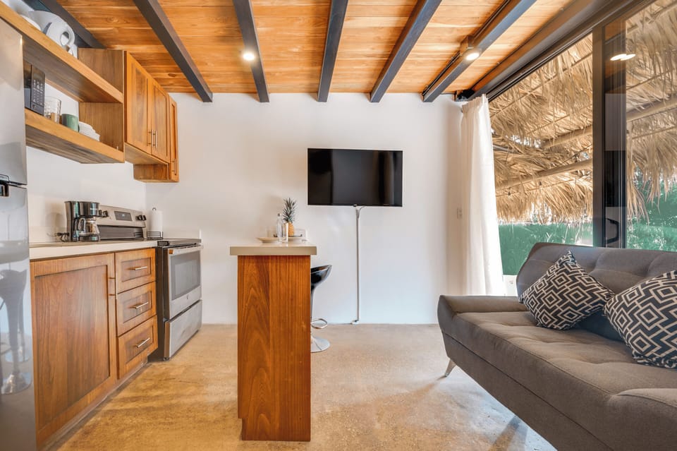  Living area — Smart TV, sofa, kitchen view.