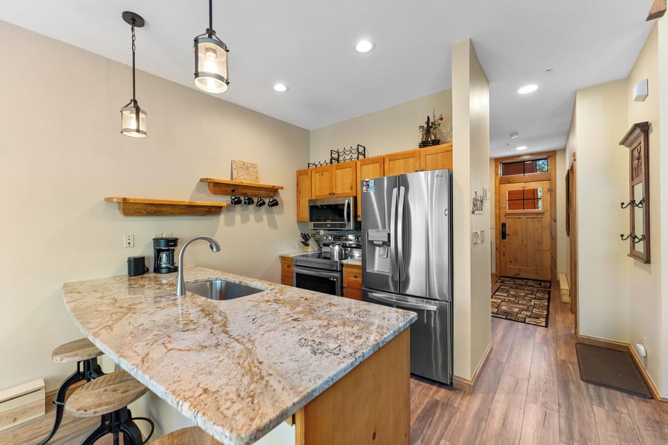 Your gourmet kitchen features granite countertops, stainless appliances, and rustic wood touches—perfect for creating memorable meals together.