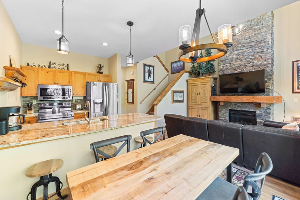 Cozy up in this stylish open-concept space where your kitchen flows seamlessly into the living room, complete with stone fireplace.