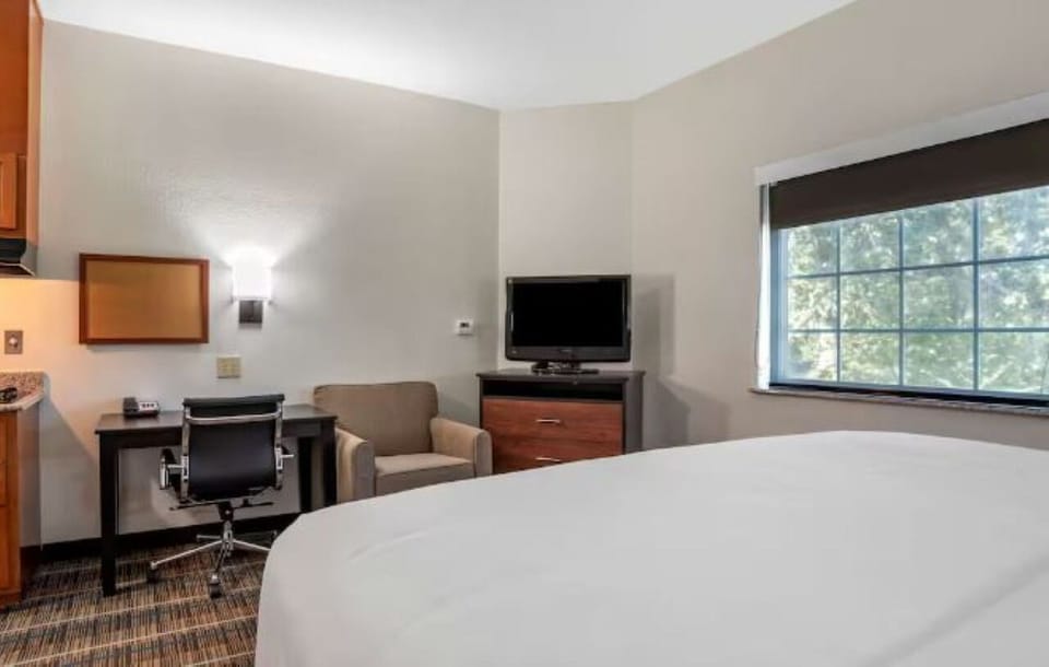 Settle in with a roomy work desk and cozy chair.