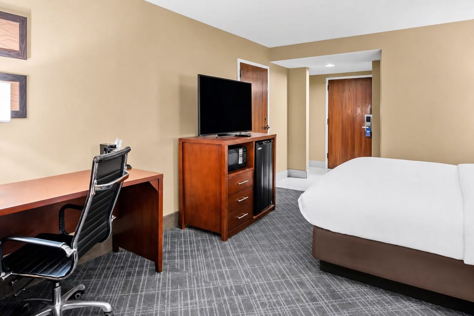 Get productive at the desk with TV and mini-fridge nearby.