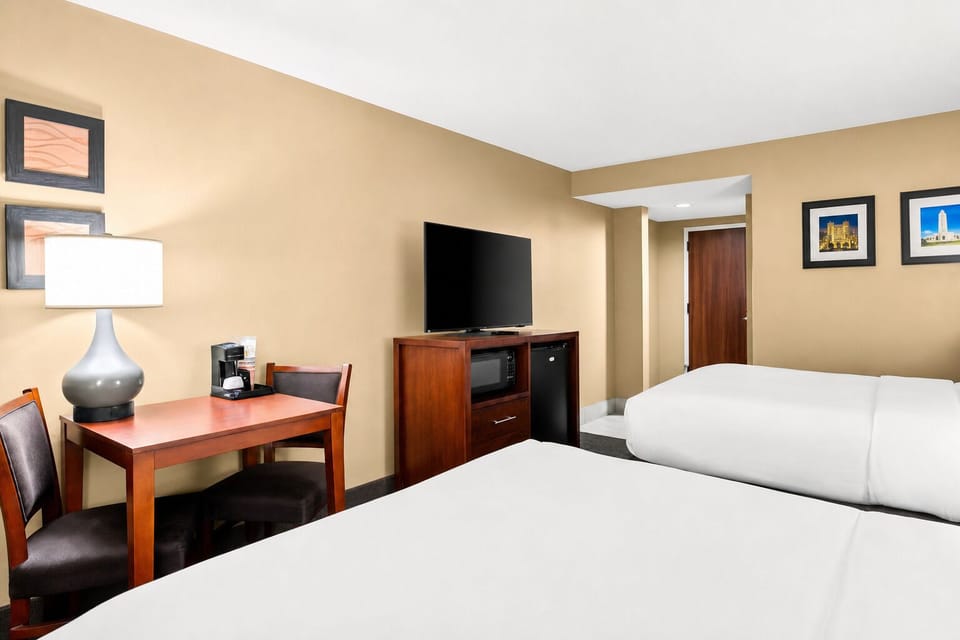Settle in with a cozy workspace, big TV, and comfort.