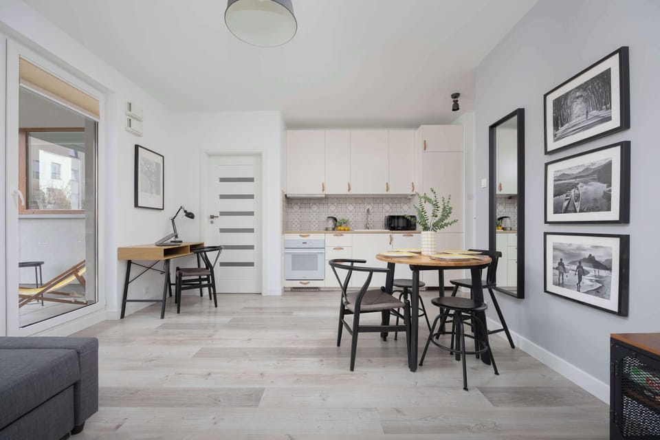 The spacious living area with kitchen and dining space impresses with brightness and cohesive design, creating the perfect spot for cooking and relaxing together.
