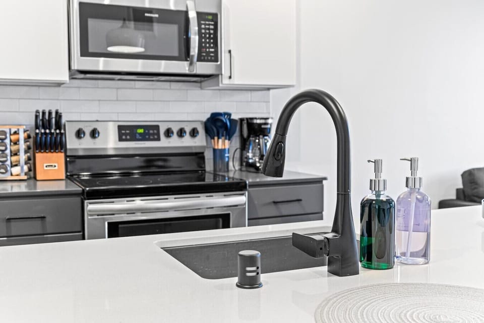 Kitchen: Sleek design meets style with modern appliances and vibrant accents for culinary adventures!