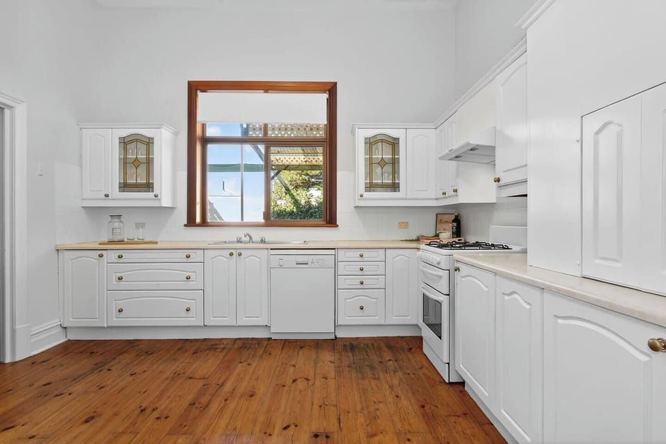 Cook with ease in the bright, fully equipped kitchen featuring gas cooking and modern appliances like a dishwasher, oven, and Nespresso coffee machine.
