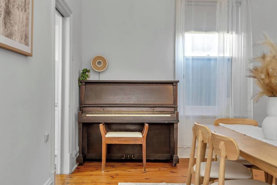 Add warmth to evenings with the upright piano—a nostalgic touch that brings personality and creativity into the dining space.
