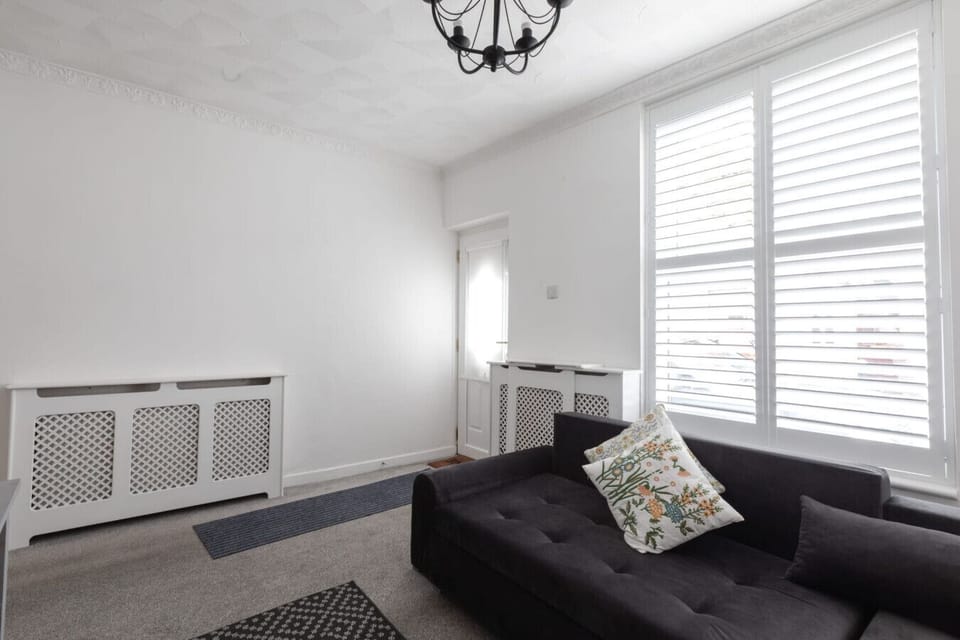 Living room with large L-shaped sofa and bay window