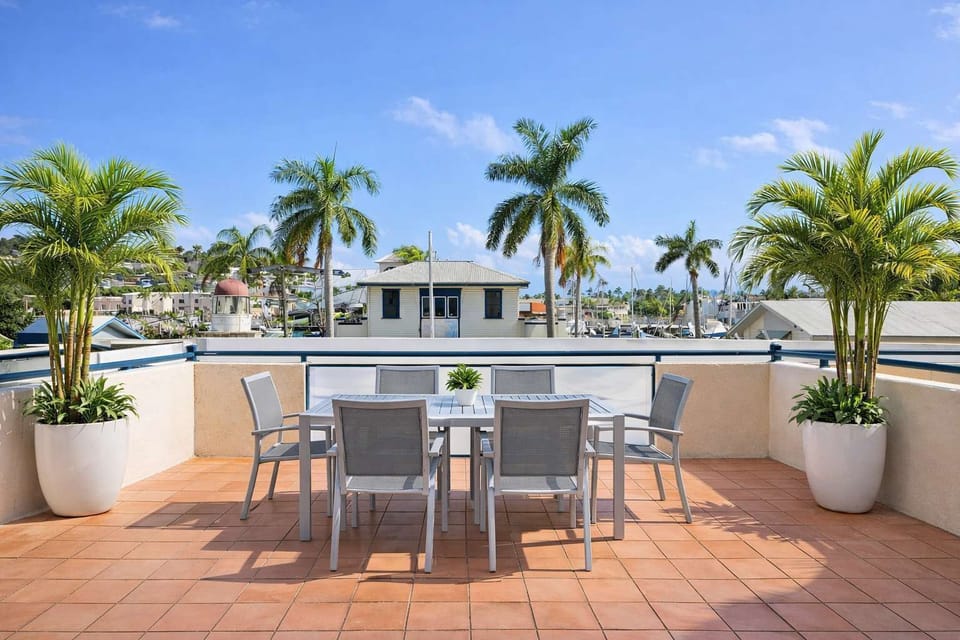 Outdoor terrace with dining setting and coastal views
