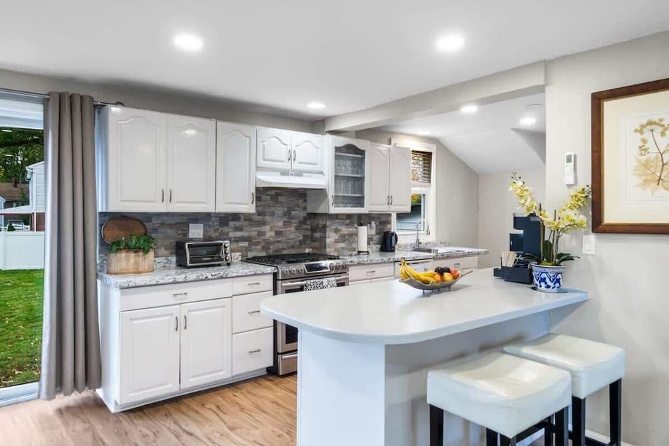 Fully equipped kitchen with stainless-steel appliances, gas stove, microwave, kettle, and coffee maker—ready for everyday cooking or weekend brunch.