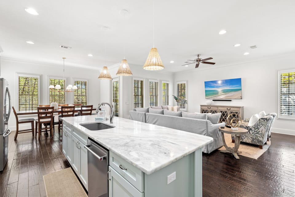 Gather around your spacious kitchen island while natural light streams through plantation shutters, creating the perfect spot for morning coffee or evening conversations.