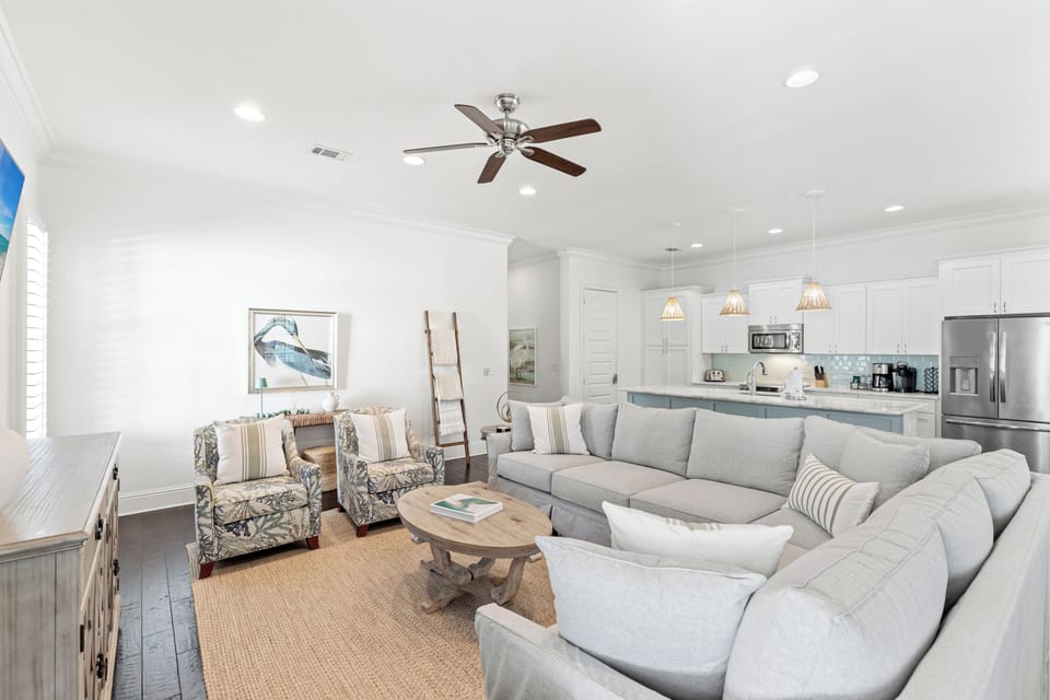 Sink into plush sectional seating where coastal charm meets modern comfort in your open-concept living space.