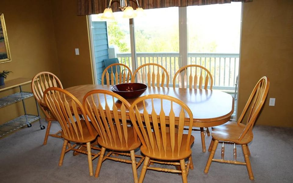 Wooden dining set for six, with sliding doors that open to scenic views and fresh air.