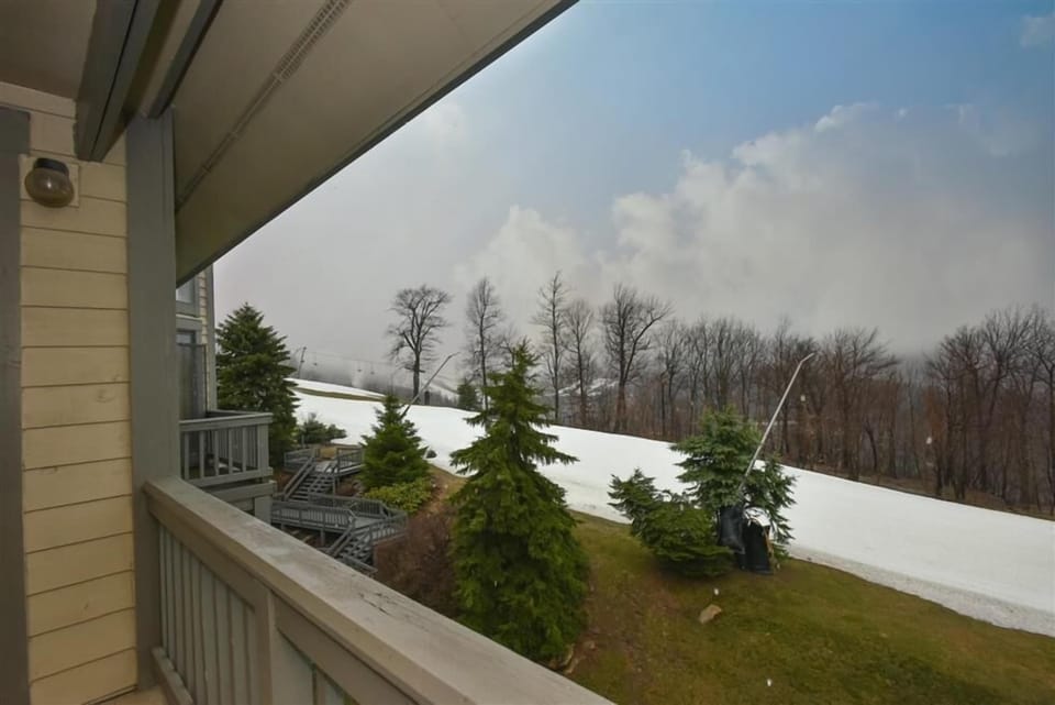 Private deck overlooking the mountains and slopes, where fresh air and scenic views invite calm reflection.