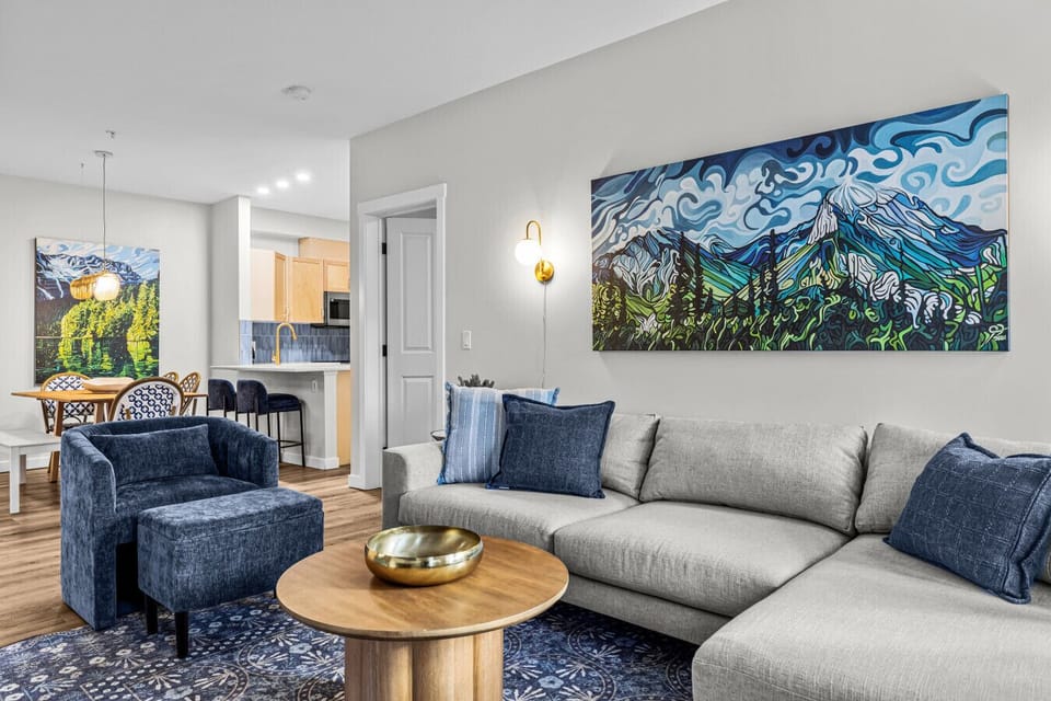 Stylish and comfortable living area recently renovated by a professional interior designer. Artwork by local artist Jeff Dillon adorns the walls.