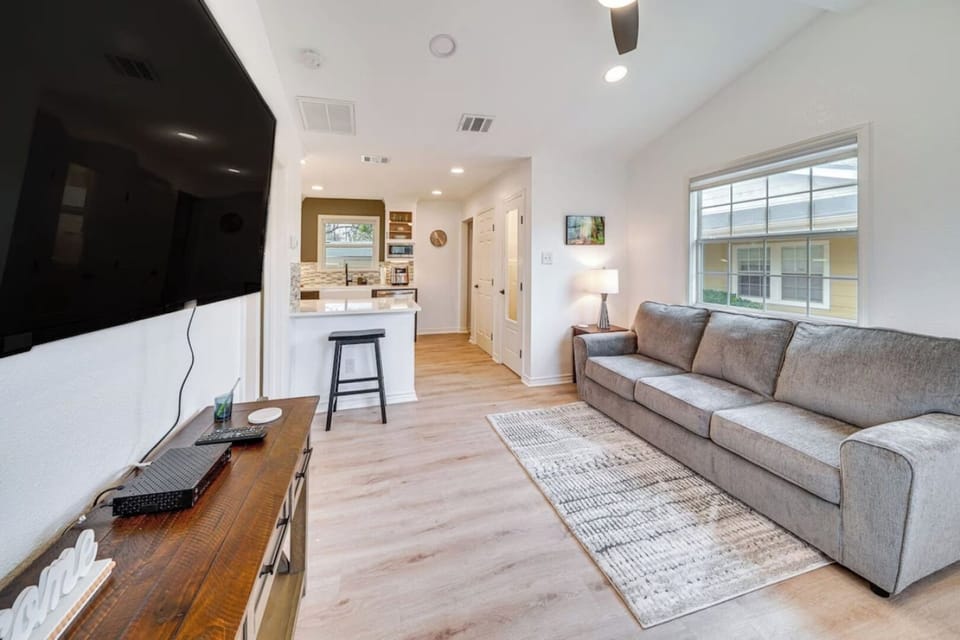 Kick back and relax in this cozy living room, complete with a comfy sofa and a Smart TV for your entertainment.