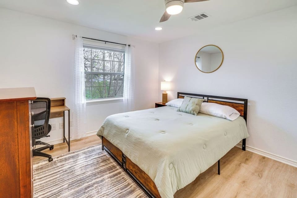 Rest and recharge in this cozy bedroom, complete with a comfortable workspace for work or travel planning.