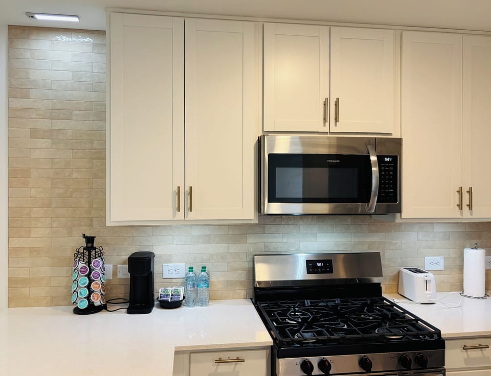 Full kitchen with stove, microwave and refrigerator. 