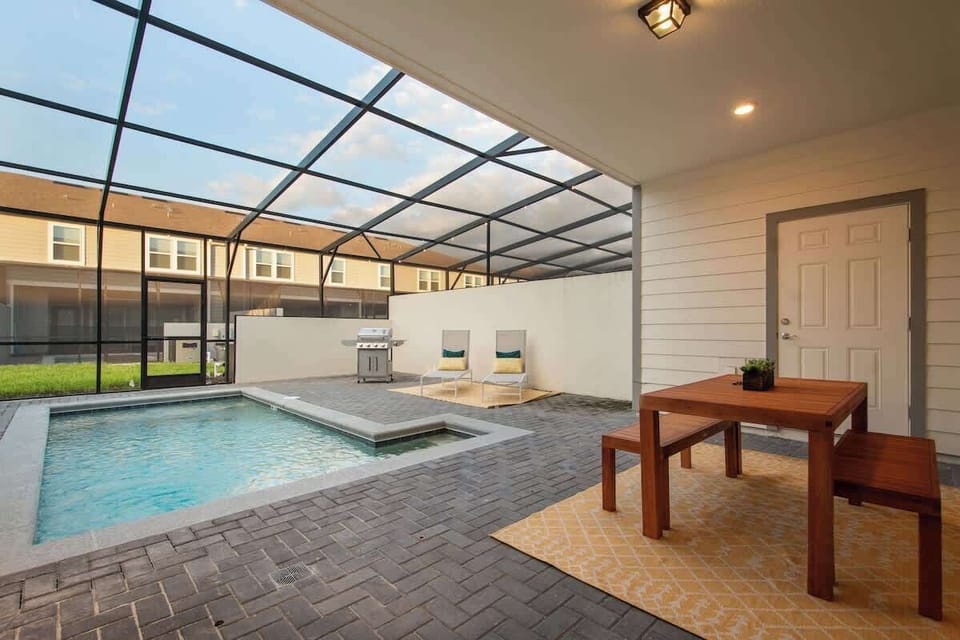 Enjoy your private screened pool oasis with comfy loungers, outdoor dining area, and a BBQ grill for easy meals. Swim, relax under the sun, and gather with family and friends for unforgettable days and cozy evenings at your Airbnb retreat.