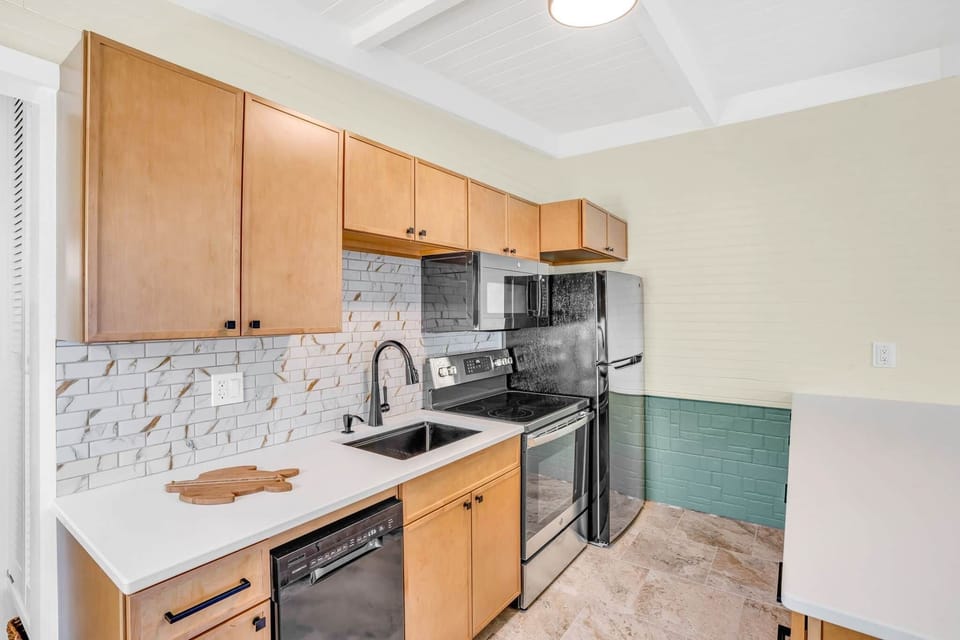 Kitchen with dishwaser, fridge microwave and stove oven
