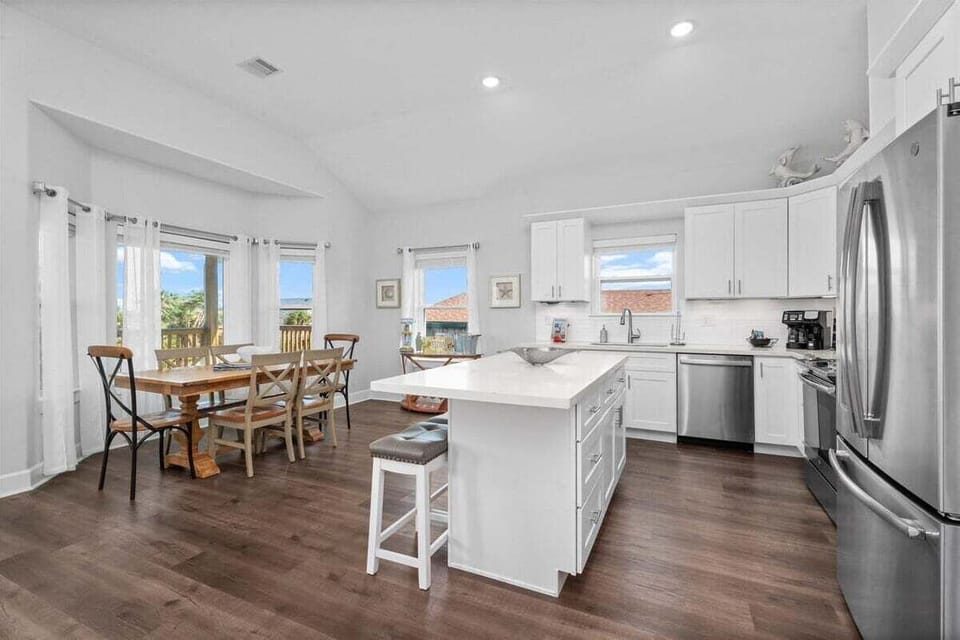 Gourmet kitchen with large island, bar seating, and high-end appliances.
