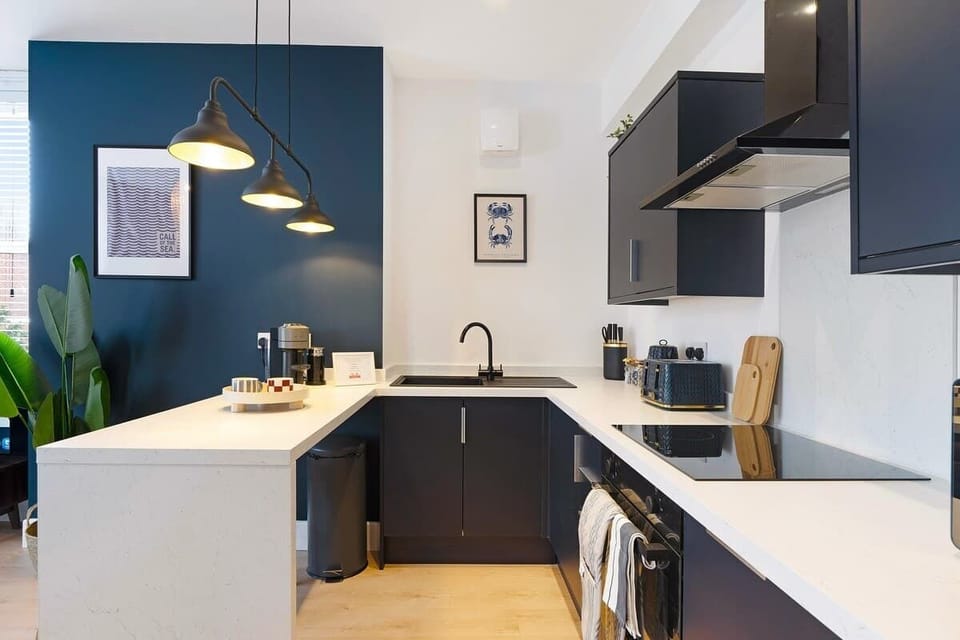 Kitchen equipped with all essentials, including a washer & dryer, oven, fridge and full cookware set.