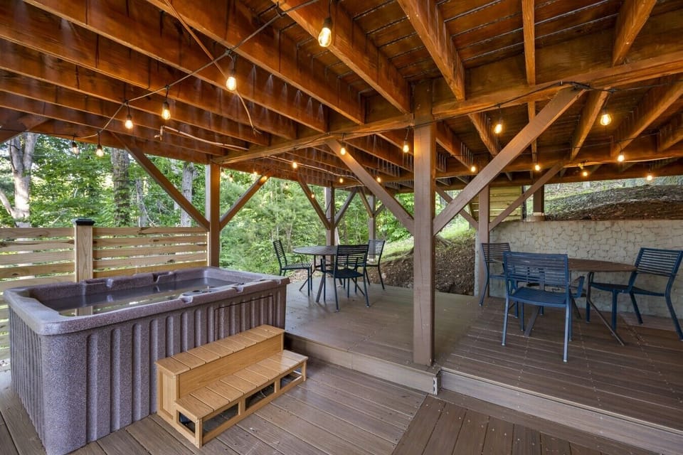 Soak in the private hot tub under string lights