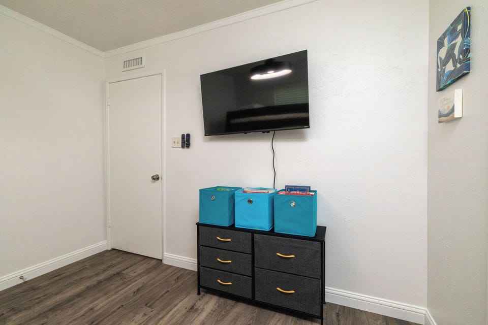 Bedroom 2 features a bunk bed with kids books & games, Roku TV, and luggage rack