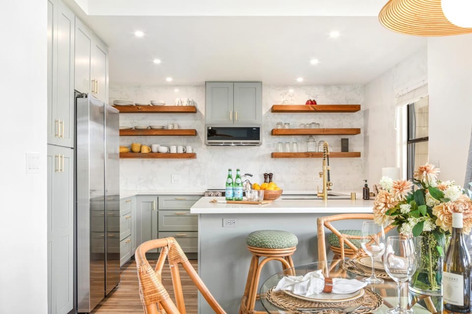 Bright kitchen with quartz counters, breakfast bar, and open shelving - newly renovated! KRV-514