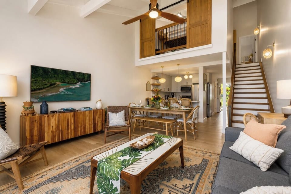 Your open-concept living room blends comfort and style with vaulted ceilings and indoor-outdoor flow.