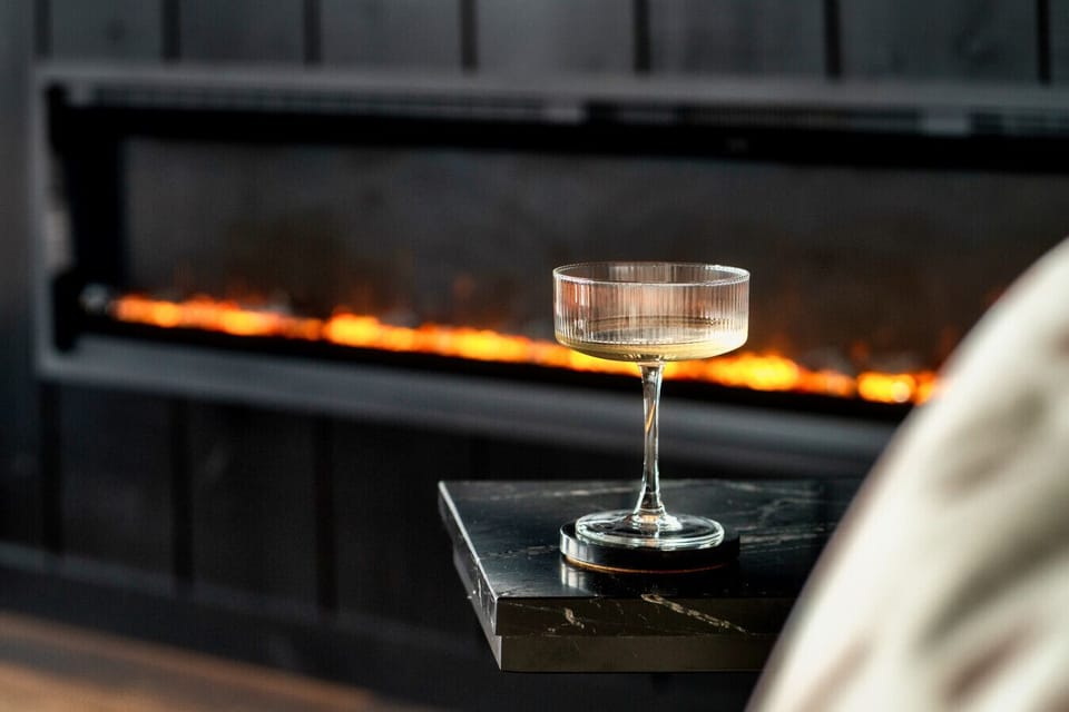 Cozy up by the fireplace with a drink!