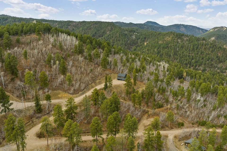 Enjoy breathtaking panoramic views from this exclusive, serene setting surrounded by lush forest.