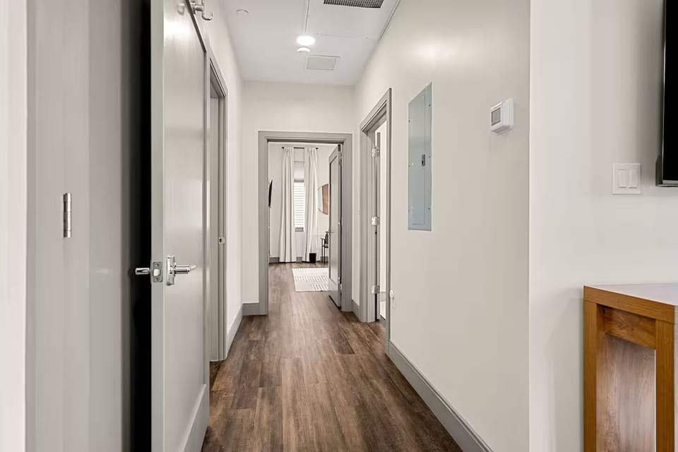 Bright hallway connecting rooms with clean lines and simple decor.