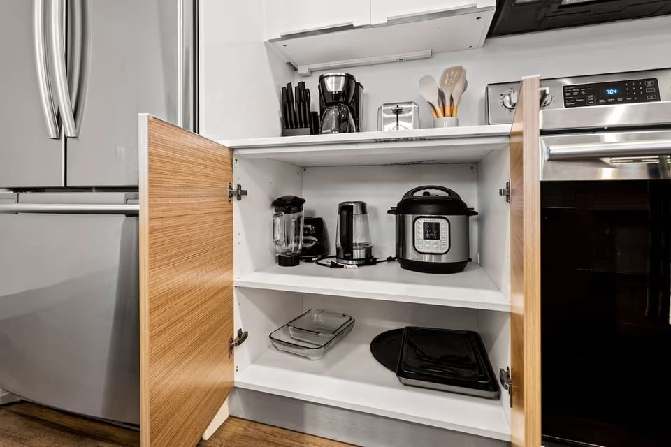 Well-stocked kitchen cabinet with essential appliances - everything you need.