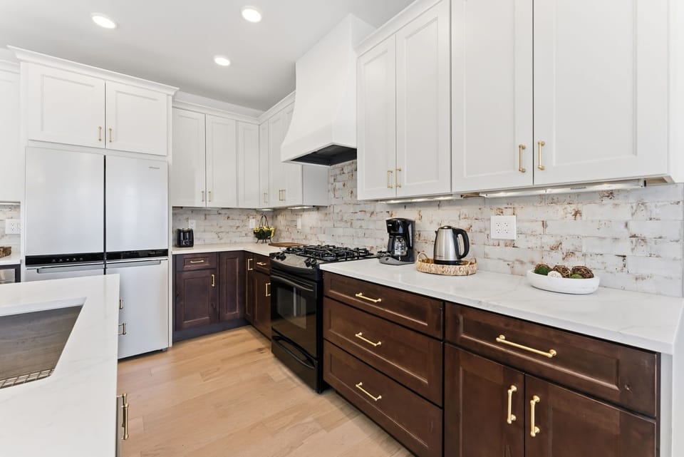 Kitchen [main floor]: Drip coffee maker, KitchenAid appliances, blender, kettle, cooking utensils, tableware