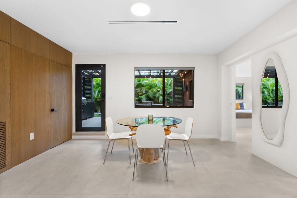 Dining area with outdoor kitchen access and a nearby powder room