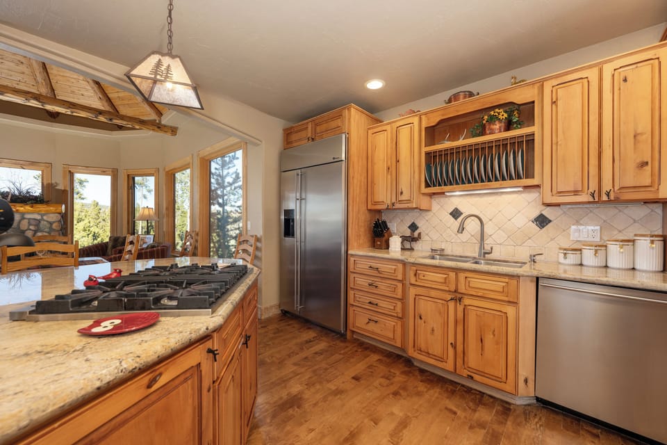 You'll love cooking in this spacious kitchen with rustic wood cabinets, granite counters, and stainless appliances.