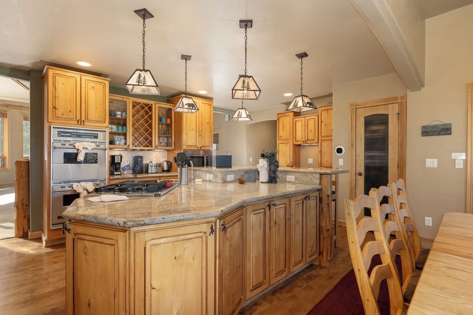 Your gourmet kitchen awaits with granite countertops, premium appliances, and warm wood cabinetry perfect for preparing memorable meals together.