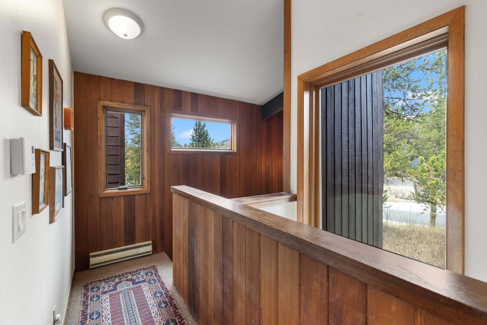 Cozy 2nd floor with wood paneling and natural light.