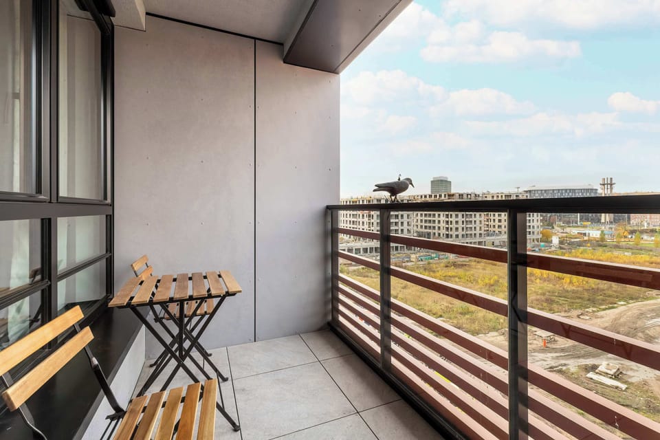 The balcony with a coffee set is the perfect spot to start your day with a cup of aromatic coffee and a city view.