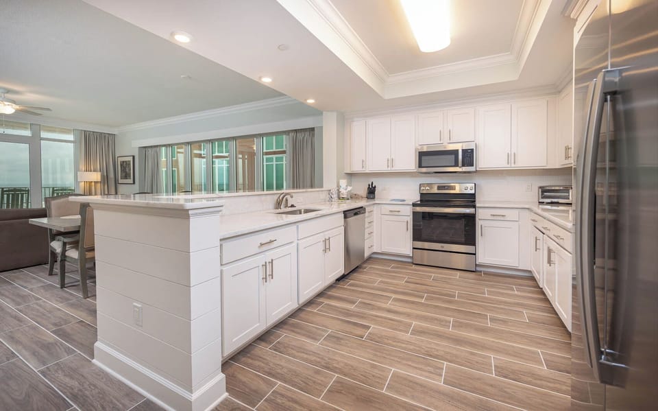 Prepare meals in this kitchen with elegant cabinetry, stainless appliances, and spacious countertops