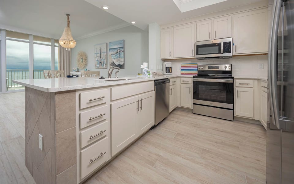 Prepare meals in this kitchen with elegant cabinetry, stainless appliances, and spacious countertops