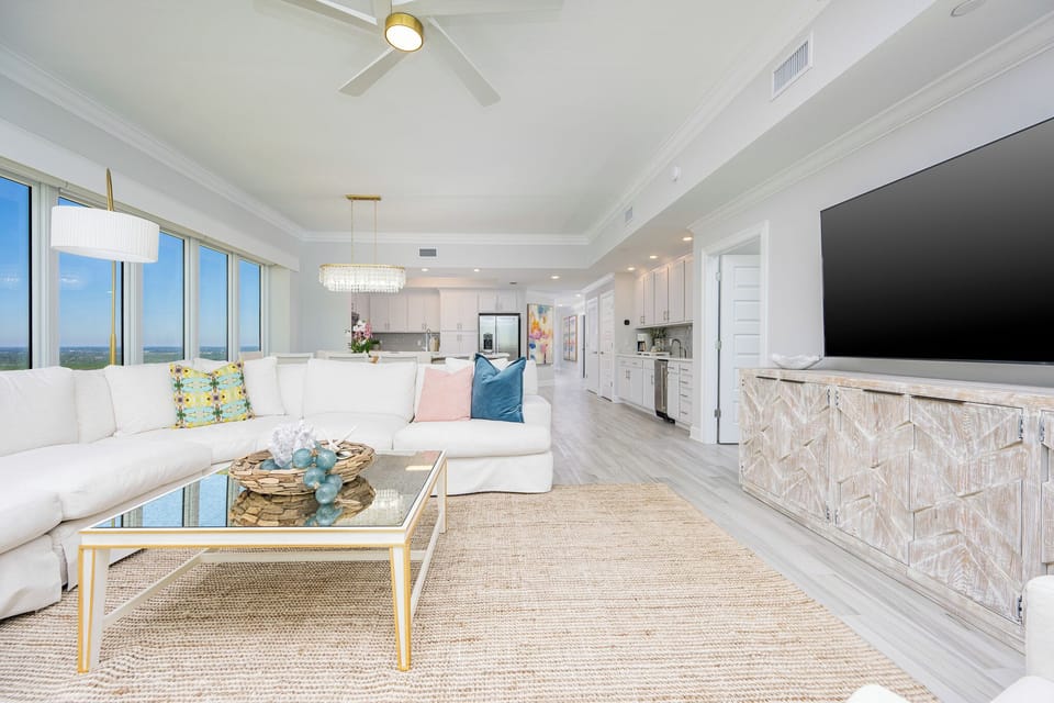 Relax on the cozy sofa in this inviting family room with your favorite show after a day at the beach