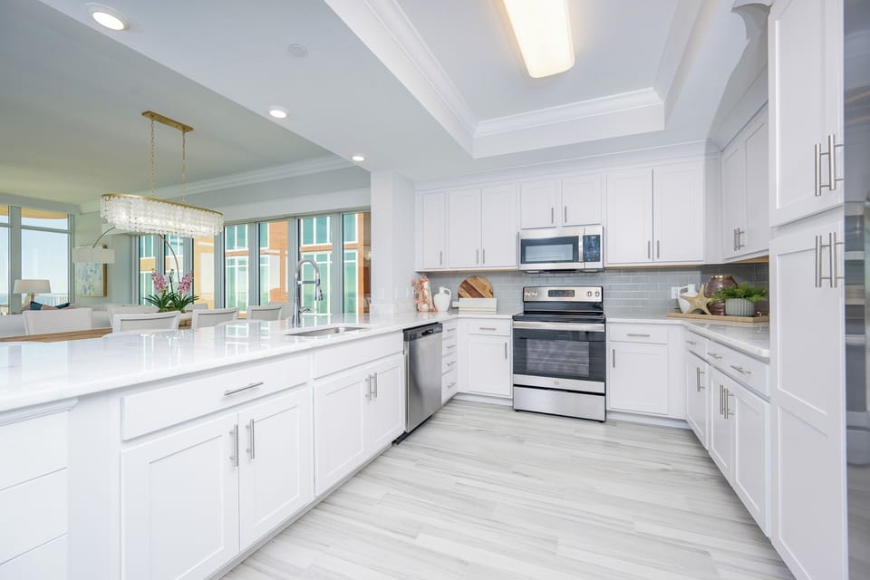 Prepare meals in this kitchen with elegant cabinetry, stainless appliances, and spacious countertops
