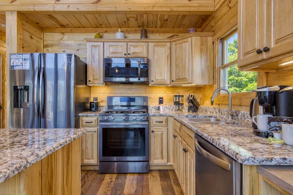 Modern kitchen with upgraded stainless steel appliances, gas cooktop, and ample cabinet space—perfect for preparing meals just like home.