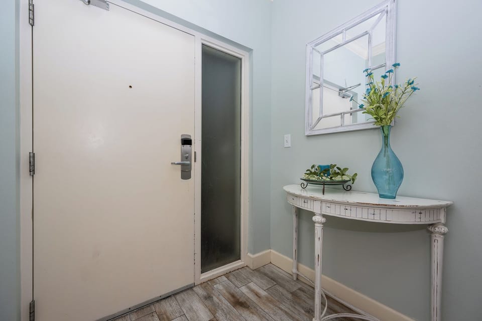 Step into this charming entryway, where fresh decor welcomes you, setting the tone for your coastal escape