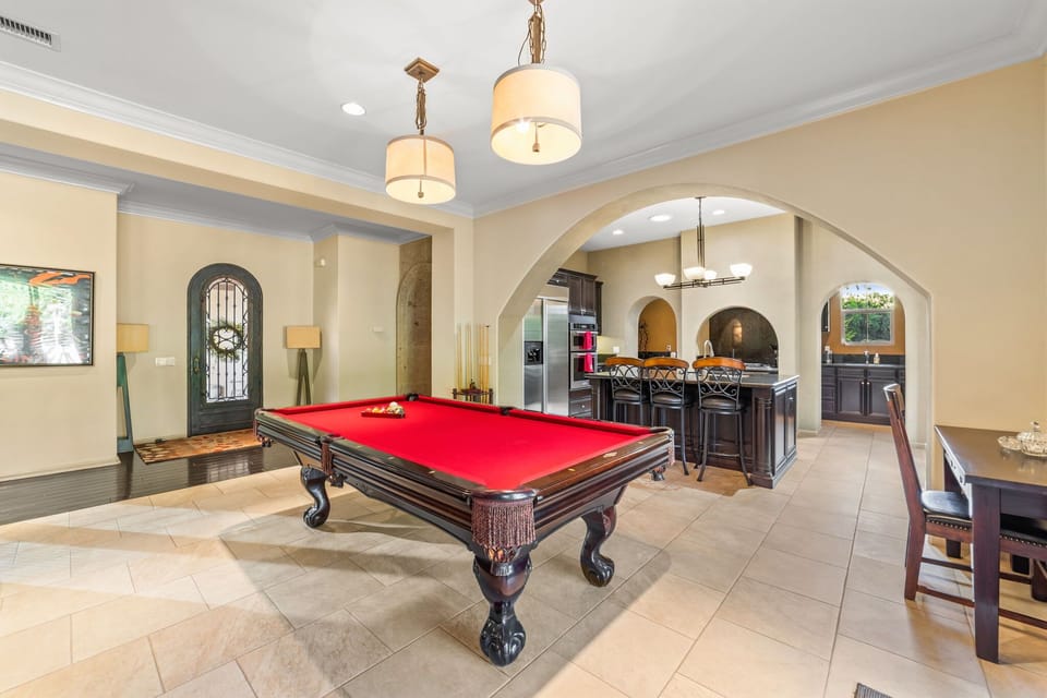 Bright entertainment area with pool table and lounge seating.