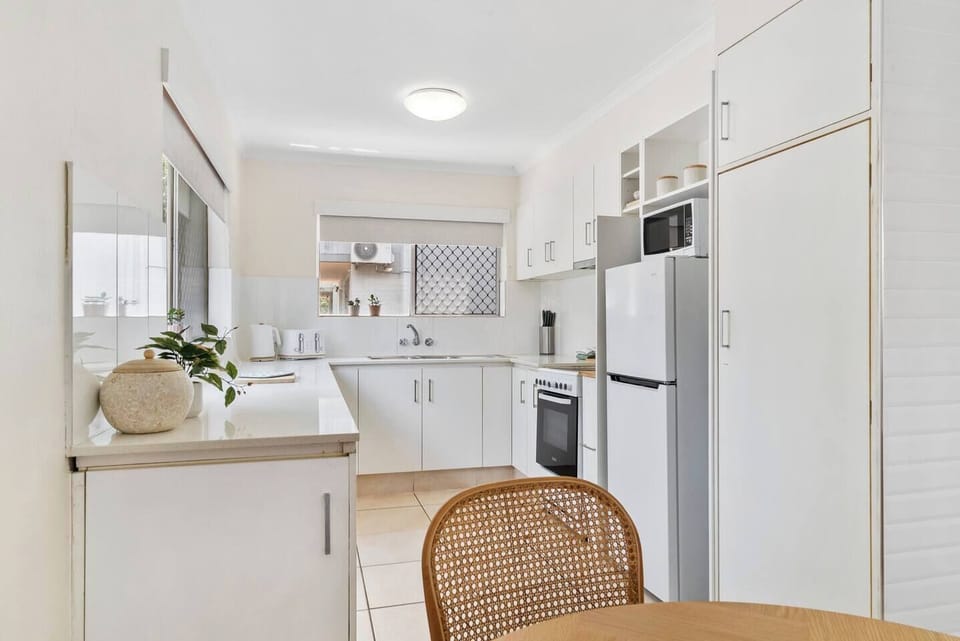 Prepare your favourite meals in the fully equipped kitchen offering an oven, stove, microwave, fridge, kettle, toaster, and pour-over coffee setup.