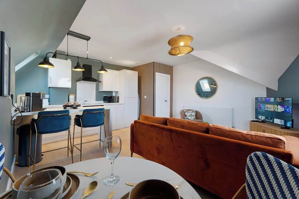 Settle into a stylish living room equipped with a Smart TV and comfortable seating, offering a relaxing environment for guests to enjoy.